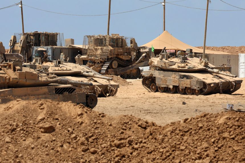 Israeli military vehicles are positioned along the border with the Gaza Strip on Thursday.