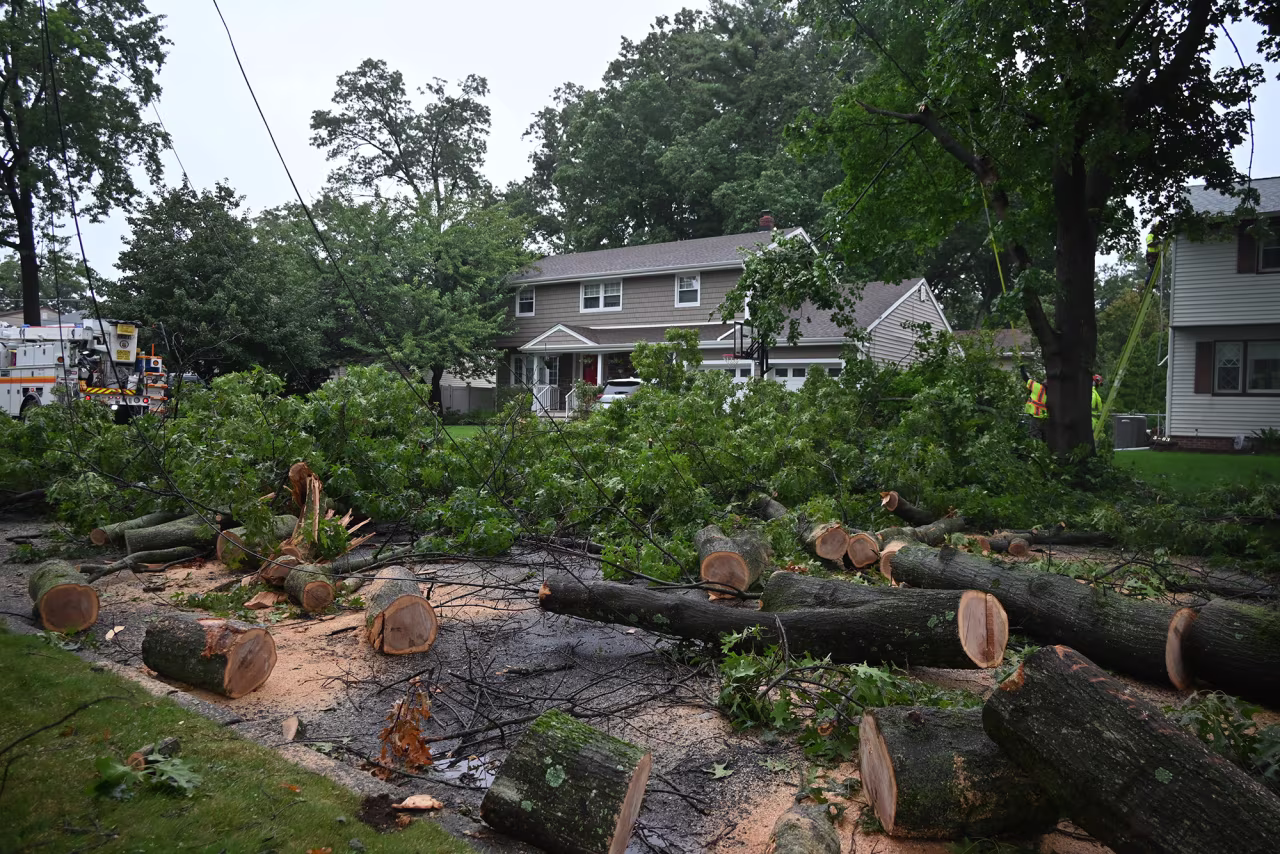 Crews work at the scene where trees and power lines went down as the effects from Hurricane Erin in Fair Lawn, New Jersey, on Thursday.