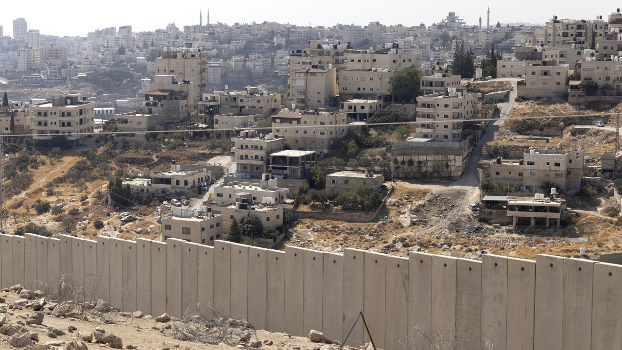 A view over the separation wall and the Arab village of Al-Eizariya, near where the Israeli government plans to build a new neighborhood as part of E1 settlement project on August 22, 2025 in near Jerusalem, Israel.