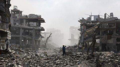 TOPSHOT - A Palestinian youth stands on a street strewn with rubble following an explosion in the Saftawi neighbourhood, west of Jabalia in the northern Gaza Strip on August 25, 2025, amid the ongoing war between Israel and the Palestinian militant group Hamas. Israeli Defence Minister Israel Katz vowed on August 22, to destroy Gaza City if Hamas did not agree to disarm, release all remaining hostages in the territory and end the war on Israel's terms. (Photo by BASHAR TALEB / AFP) (Photo by BASHAR TALEB/AFP via Getty Images)          