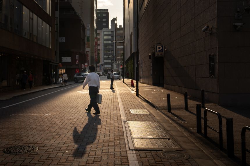 On August 21, 2025, a man crosses the road during the hot season in Tokyo, Japan.