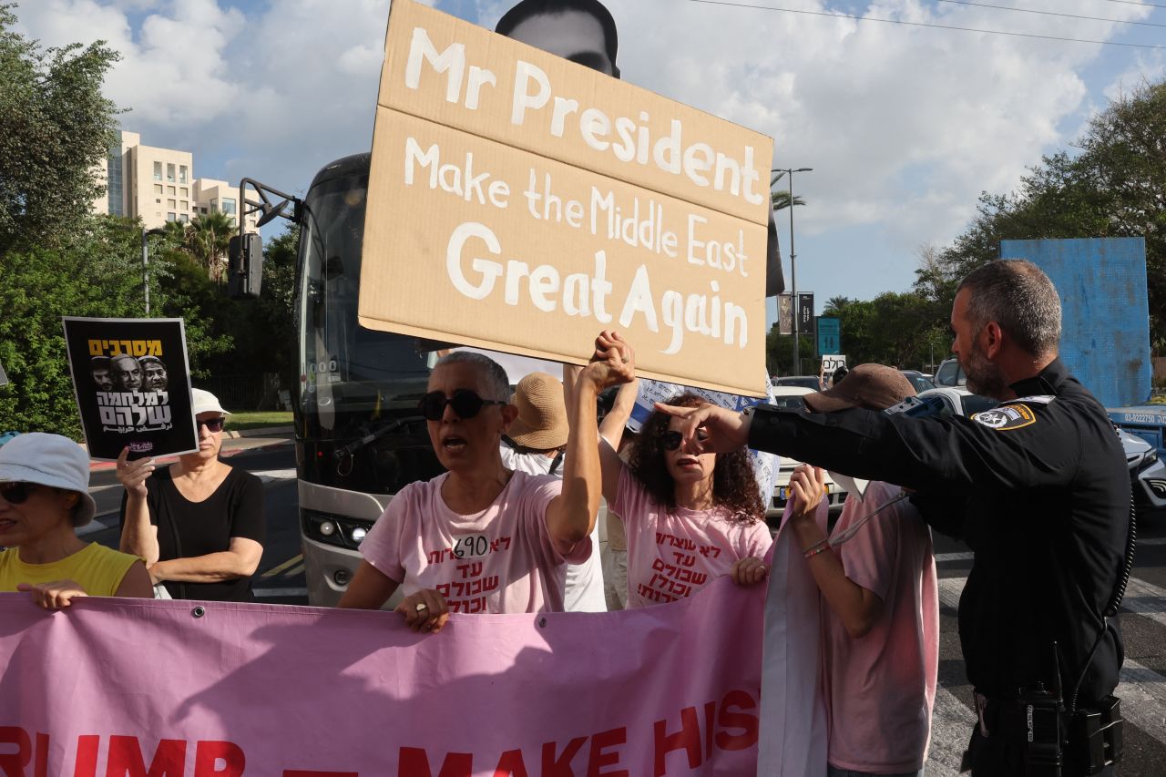 An Israeli police officer in Tel Aviv tries to move protesters from the middle of the road during a demonstration organised by the families of the Israeli hostages taken captive in the Gaza Strip since the October 2023 attack.