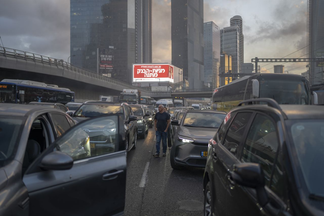 Israeli protesters block the main highway in Tel Aviv on Tuesday as they demand the immediate release of the hostages and an end to the war.