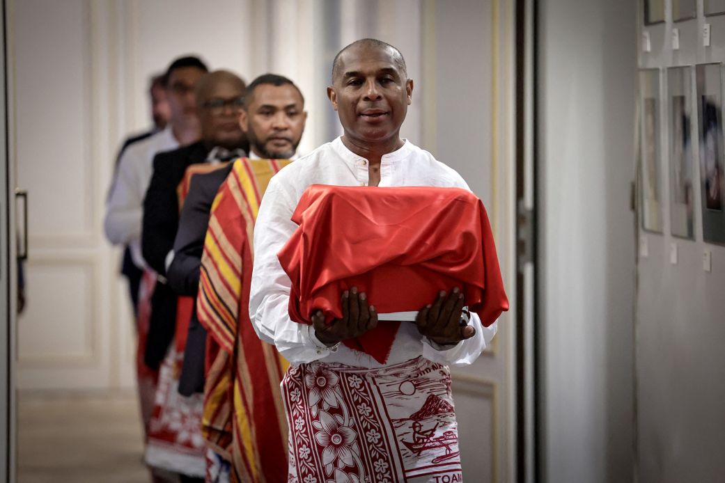 A man carries one of the three Sakalava skulls during a ceremony for their repatriation to Madagascar at the French culture ministry in Paris on Tuesday, August 26, 2025.