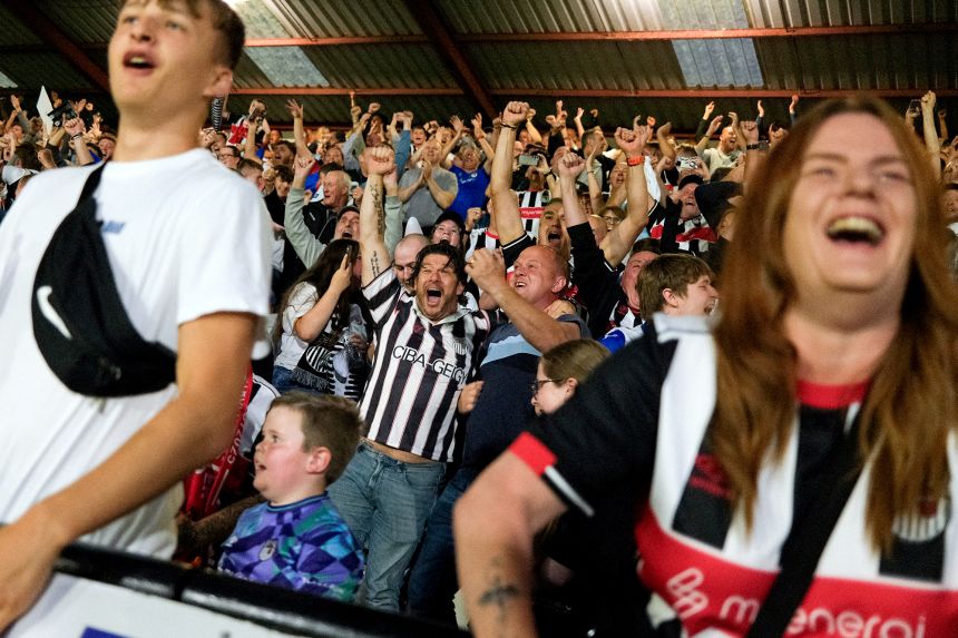Grimsby Town fans celebrate one of the biggest results in the club's history.