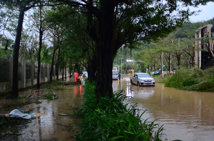 A car drives on a flooded street as Typhoon Kajiki brings strong winds and heavy rain on August 25, 2025 in Sanya, Hainan Province of China.
