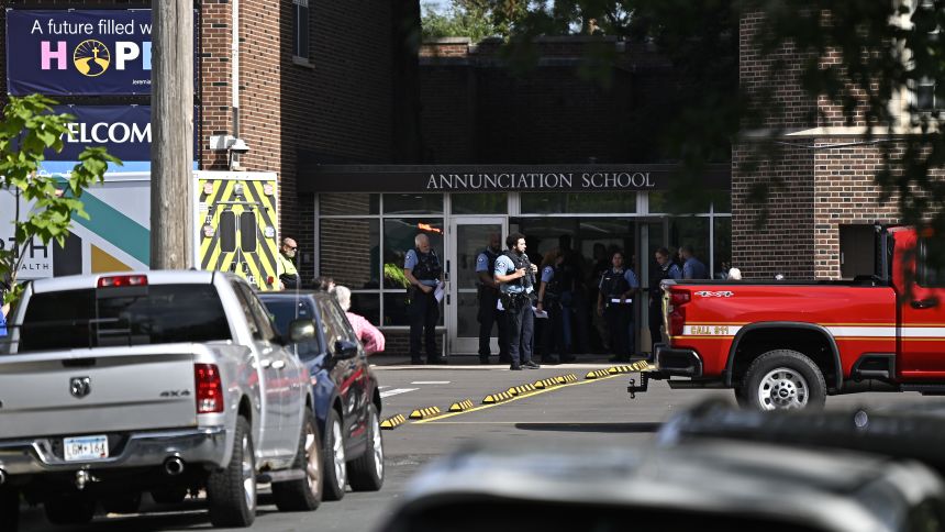 MINNEAPOLIS, MINNESOTA - AUGUST 27: Police work the scene following a mass shooting at Annunciation Catholic School on August 27, 2025 in Minneapolis, Minnesota. According to Minneapolis Police, a gunman fired through the windows of the Annunciation Church at worshippers sitting in pews during a Catholic school Mass, killing two children and injuring at least 17 others. The gunman reportedly died at the scene from a self-inflicted gunshot wound. (Photo by Stephen Maturen/Getty Images)