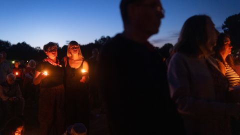 MINNEAPOLIS, MINNESOTA - AUGUST 27: People attend a vigil at Lynnhurst Park to mourn the dead and pray for the wounded after a gunman opened fire on students at Annunciation Catholic School on August 27, 2025 in Minneapolis, Minnesota. According to Minneapolis Police, the gunman fired through the windows of the Annunciation Church while worshippers were sitting in pews during a Catholic school Mass, killing two children and injuring at least 17 others. The gunman died at the scene from a self-inflicted gunshot wound, according to police. (Photo by Scott Olson/Getty Images)