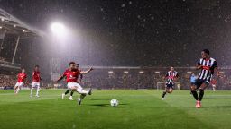 GRIMSBY, ENGLAND - AUGUST 27: Matheus Cunha of Manchester United crosses the ball as rain falls during the Carabao Cup Second Round match between Grimsby Town and Manchester United at Blundell Park on August 27, 2025 in Grimsby, England.  (Photo by George Wood/Getty Images)