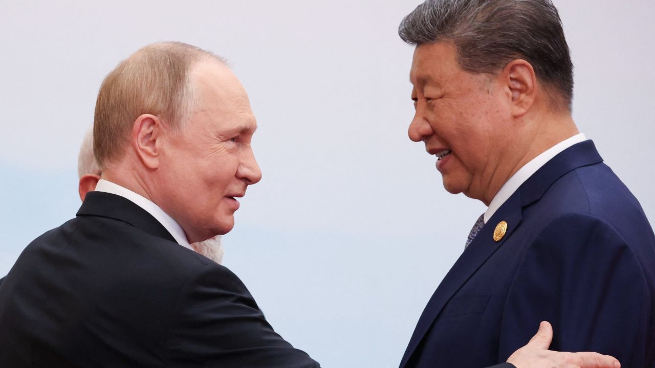 In this pool photograph distributed by the Russian state agency Sputnik, Russia's President Vladimir Putin  speaks with China's President Xi Jinping during the Shanghai Cooperation Organisation (SCO) Summit in Tianjin on September 1, 2025.