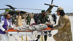 Afghan volunteers and Taliban security personnel carry an earthquake victim evacuated by a military helicopter from the Nurgal district of Kunar province, after his arrival for medical assistance in Jalalabad on September 1, 2025. A massive rescue operation was underway in Afghanistan on September 1, after a strong earthquake and multiple aftershocks flattened homes in a remote, mountainous region, killing more than 800 people, the Taliban authorities said. (Photo by Wakil KOHSAR / AFP) (Photo by WAKIL KOHSAR/AFP via Getty Images)          