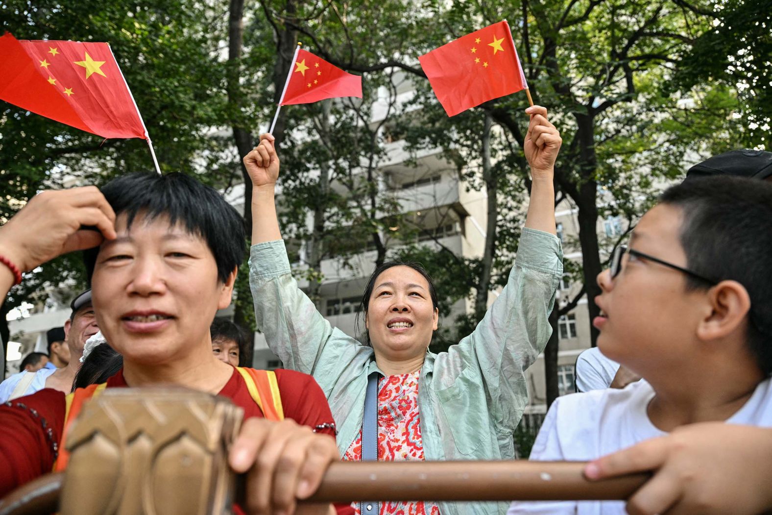 People gather on a street outside the parade in Beijing.