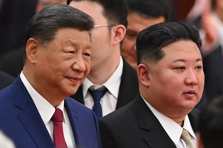 Chinese leader Xi Jinping (L) and North Korean leader Kim Jong Un arrive for a reception in the Great Hall of People, following a military parade in Beijing on September 3, 2025.