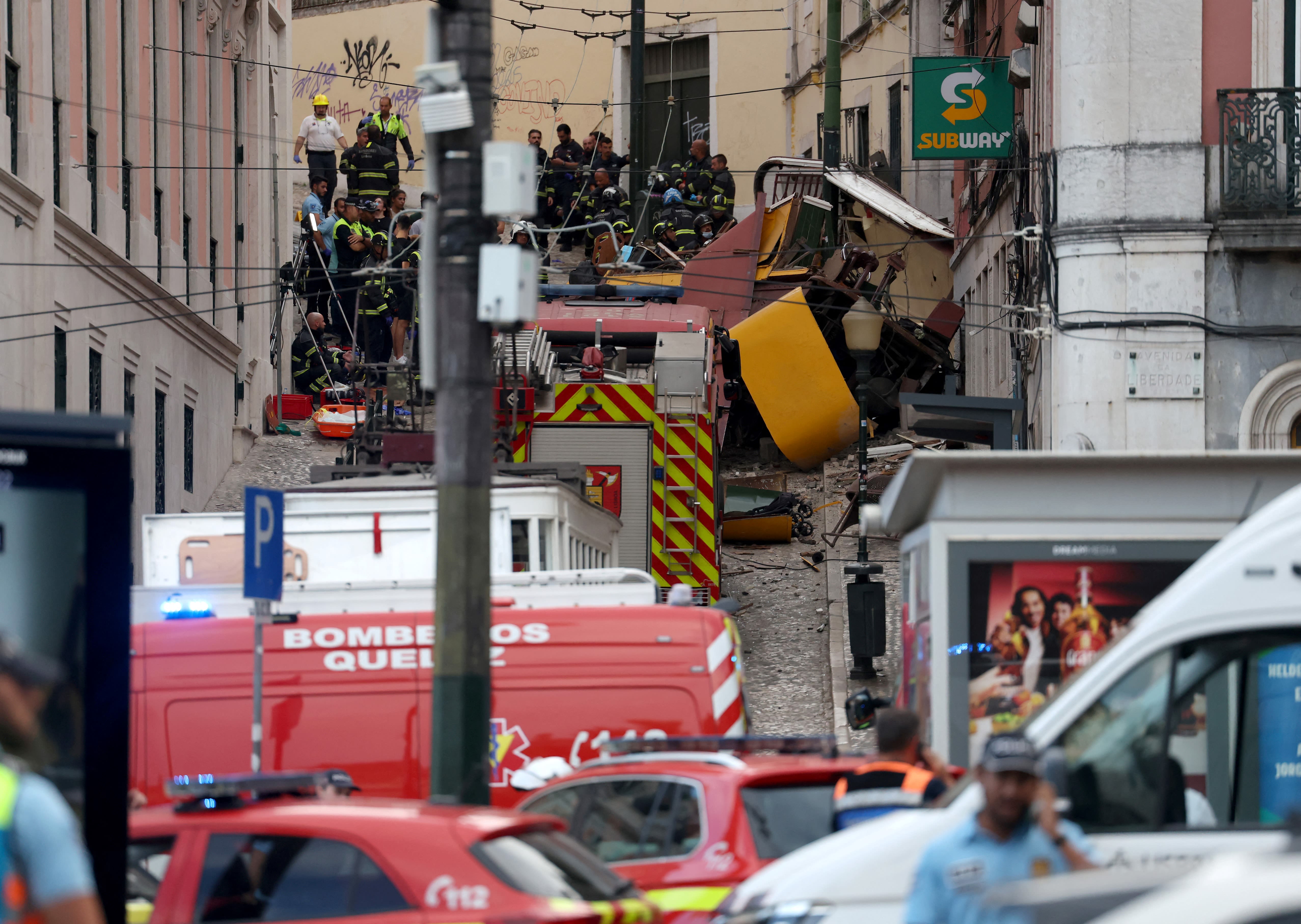 Police and firefighters work on the site of a funicular railway accident in Lisbon, Portugal today.