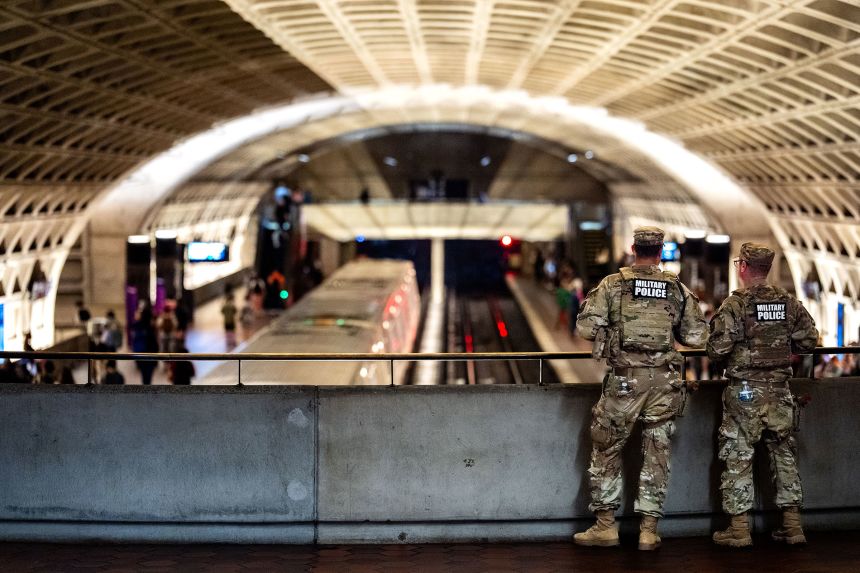 National Guard Military Police watch as trains arrive and depart at Washington, DC's L'Enfant Plaza station on September 4.