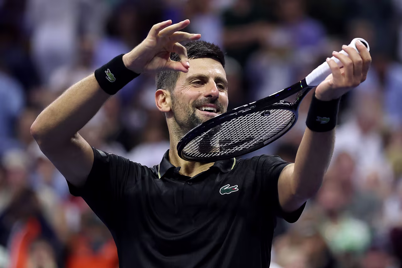 Novak Djokovic plays his racket like a violin after winning his fourth-round match on Sunday.