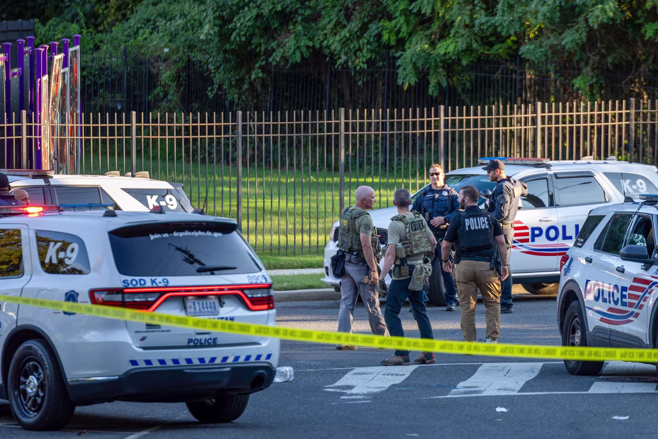 Washington DC Metro Police, FBI, ATF and other federal agents work on the scene of a shooting in southeast Washington, DC, on Monday.