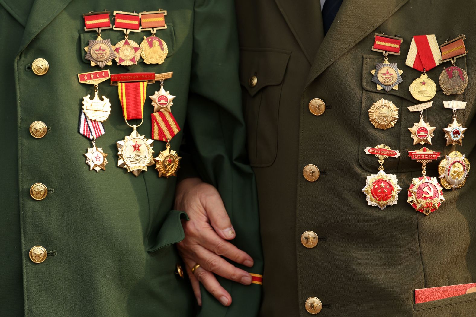 War medals on the uniforms of military veterans attending the event.