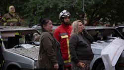 Local residents stand next to a damaged car in front of a heavily damaged residential building following Russian drone and missile strikes in Kyiv on September 7, 2025, amid the Russian invasion of Ukraine. Russia fired its biggest-ever aerial barrage at Ukraine early on September 7, setting the seat of the Ukrainian government in Kyiv ablaze, authorities said. (Photo by Oleksandr Magula / AFP) (Photo by OLEKSANDR MAGULA/AFP via Getty Images)          