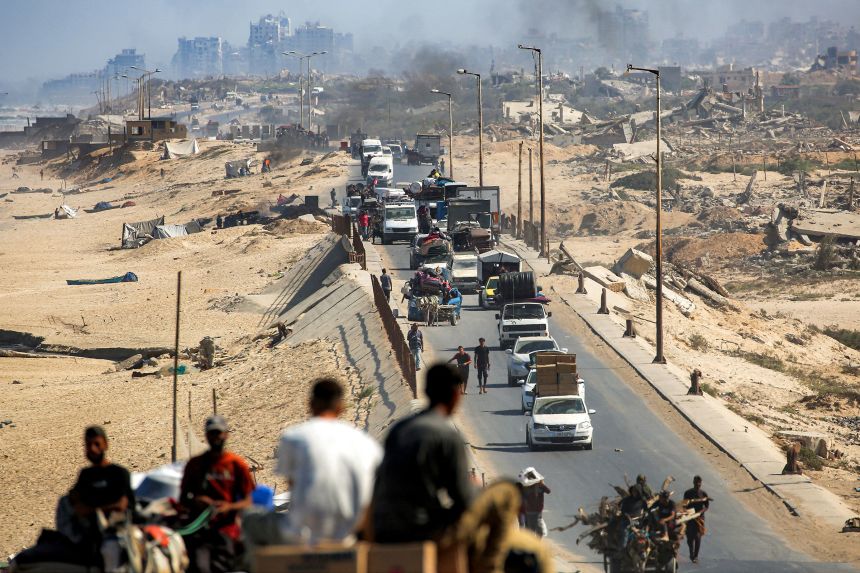 Vehicles move along the coastal road used by displaced people evacuating from Gaza City, in Nuseirat in the central Gaza Strip, on September 9, 2025.