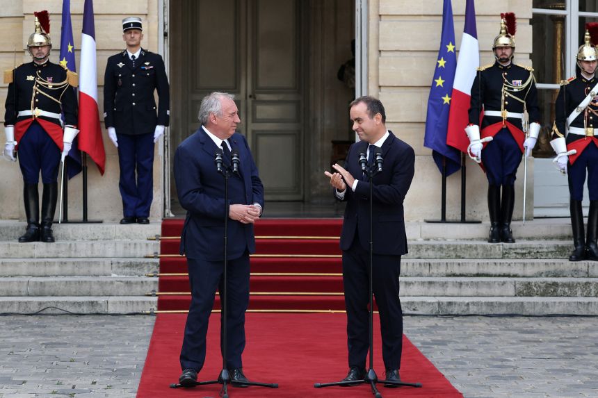 France's newly-appointed prime minister Sébastien Lecornu (right) applauds outgoing prime minister François Bayrou (left) during the handover ceremony in Paris on Monday.