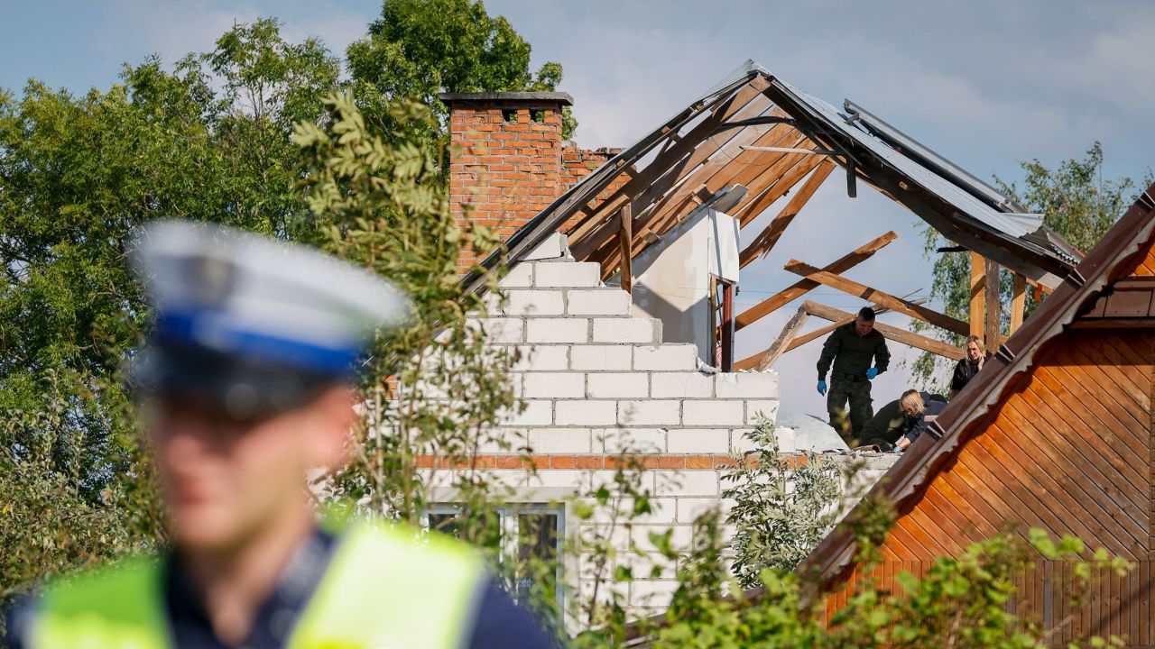 Police inspect damage to a house damaged by debris from a shot-down Russian drone in Wyryki-Wola, Poland, on September 10.