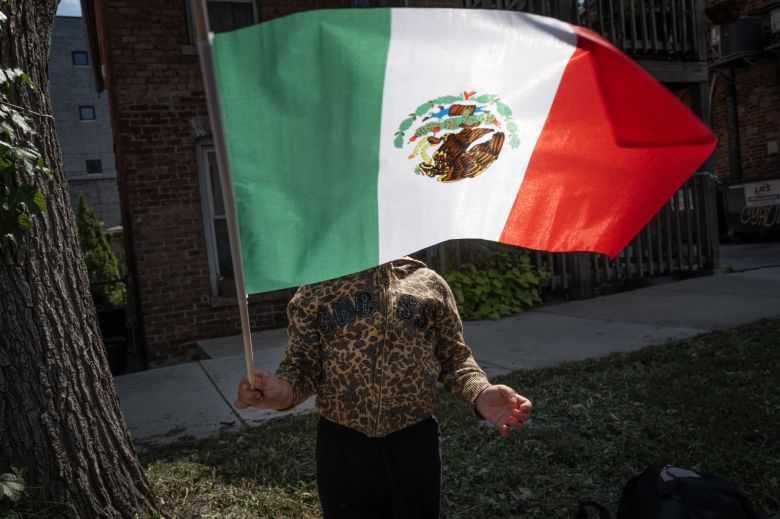 Keilina Zamora prepares to participate in the Mexican Independence Day parade along 18th Street in Pilsen Saturday