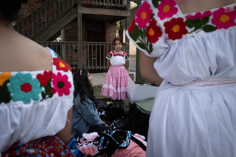 People prepare to participate in the Mexican Independence Day parade along 18th Street in Pilsen Saturday.