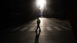 A police officer stands guard as demonstrators march through downtown Chicago during a protest against President Donald Trump's immigration policies on Saturday.
