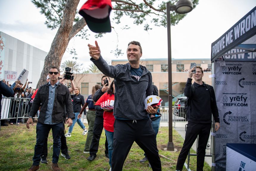 Charlie Kirk throws Trump  hats into the crowd during a stop on his American Comeback tour this spring.