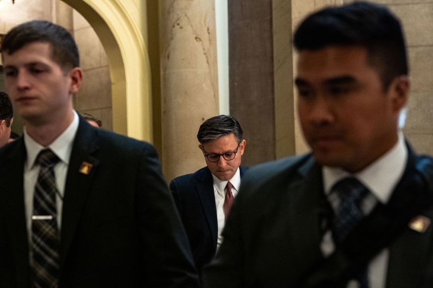 Speaker of the House Mike Johnson walks to the House floor on Thursday.