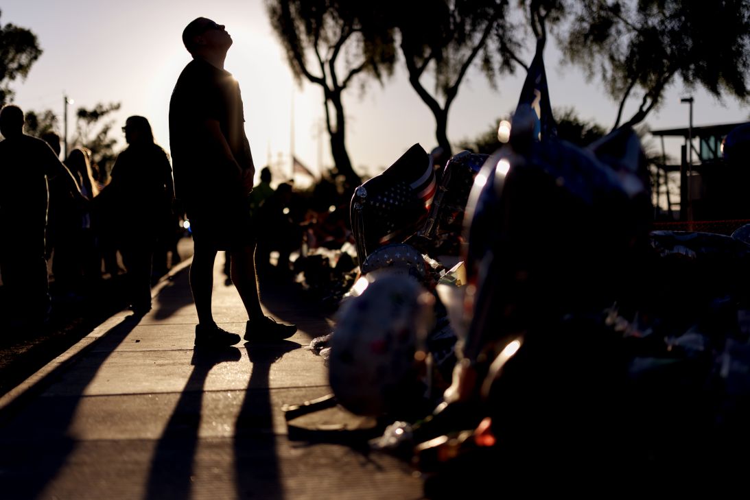 A man reacts at a memorial for Charlie Kirk at the Turning Point USA headquarters in Phoenix on September 12.