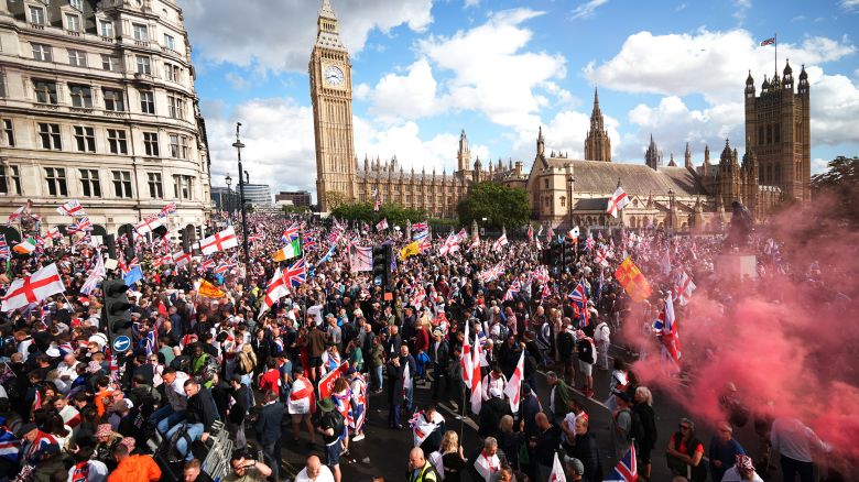 Protesters wave Union Jack and St George's England flags during the "Unite The Kingdom" rally by the Houses of Parliament on September 13, 2025 in London, England. Far-right activist Tommy Robinson (also known as Stephen Yaxley-Lennon) has invited supporters to hold a rally in central London entitled "Unite The Kingdom". The former English Defence League leader and his supporters are actively Islamophobic and racist and have been behind much of the unrest seen outside hotels housing migrants this summer. Stand Up To Racism are mounting a counter-protest to today's rally.