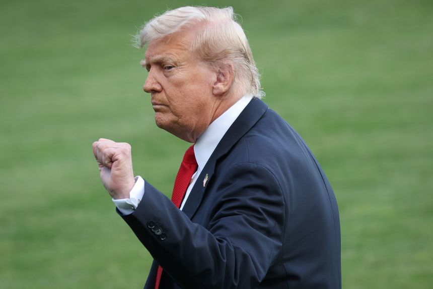 President Donald pumps his fist after taking questions from reporters on Charlie Kirk, while departing the White House on September 11, 2025.
