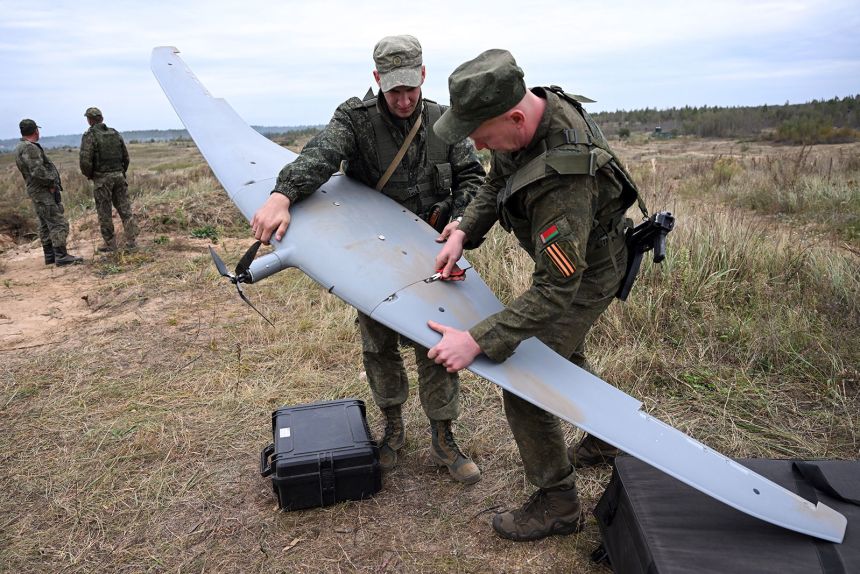 Belarus' servicemen work on an unmanned aerial vehicle (UAV) during the