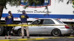 Investigators collect evidence after a man crashed his vehicle after being fatally shot during a confrontation with ICE officers on September 12 in Franklin Park, Illinois.