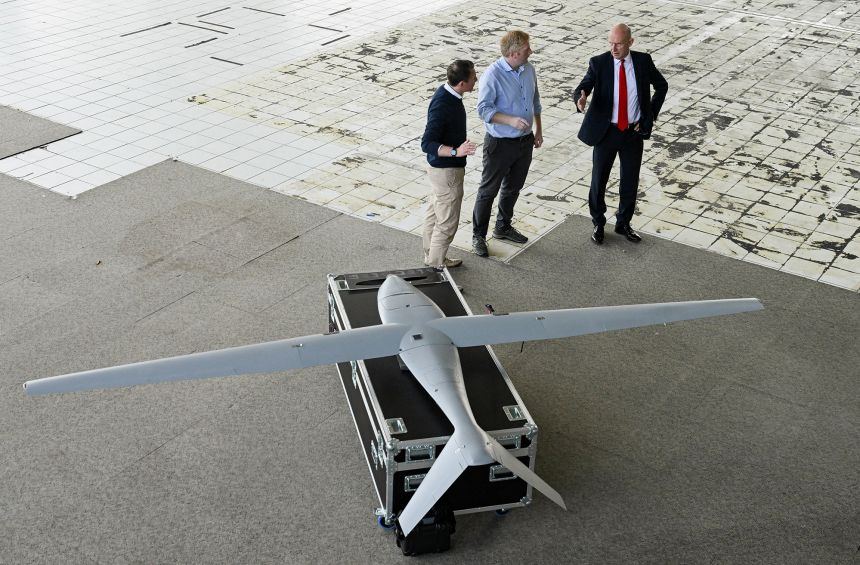 British Defense Secretary John Healy (R) and Teekbar Director Director Carl Brew (c) will tour the new Tekever military drone production facility in Swindon, southern England on September 15th, 2025.