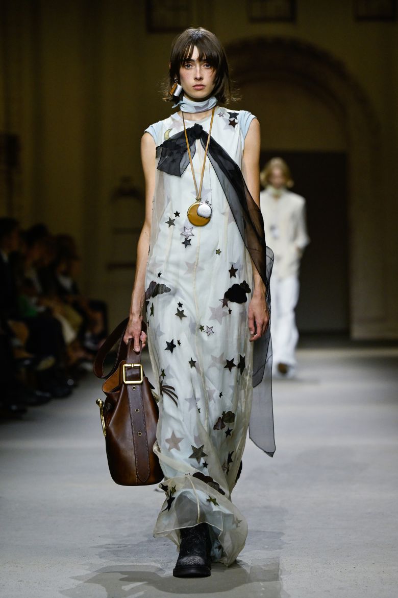 Coach's maxi shift dresses were layered organza with celestial motifs and flowing ribbon.