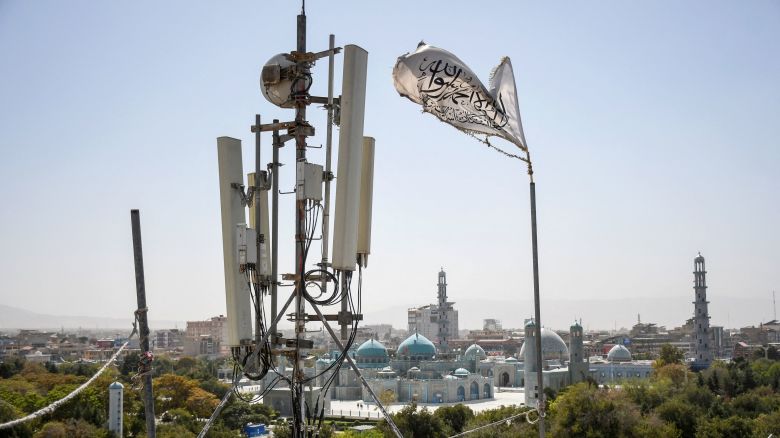 A Taliban flag flutters near telecom equipment installed over a rooftop providing internet services overlooking Hazrat-e-Ali Shrine, in Mazar-i-Sharif on Tuesday, as the Taliban administration banned fibre-optic internet in Balkh province.