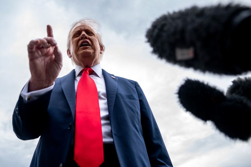 President Donald Trump speaks to members of the media, on the South Lawn of the White House before he boards Marine One on Tuesday.