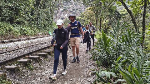 A group of tourists leaves on foot due to a protest by residents in Machu Picchu Pueblo, Peru, on September 16, 2025. Peru evacuated some 1,400 tourists overnight from the train station that serves the Inca citadel of Machu Picchu, while about 900 others remained stranded as protesters blocked the railway tracks to demand a new company be chosen to run the buses that ferry visitors from the Aguas Calientes train station, at the foot of Machu Picchu, to the site itself. (Photo by Carolina Paucar / AFP) (Photo by CAROLINA PAUCAR/AFP via Getty Images)          