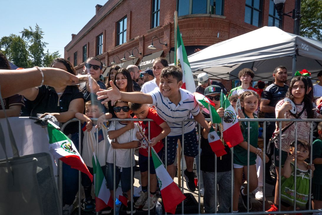 Families attended the 54th annual Mexican Independence Day Parade in Chicago's Little Village neighborhood on September 14, 2025, waving Mexican flags and some wearing the country's soccer jersey.