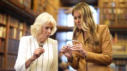 WINDSOR, ENGLAND - SEPTEMBER 18: Queen Camilla and First Lady Melania Trump look at miniature dolls' house books as they tour Queen Mary’s Dolls’ House and the Royal Library during the State visit by the President and First Lady of the United States of America at Windsor Castle on September 18, 2025 in Windsor, England. President Trump is in England from Sept. 16-18 on his second UK state visit, with the previous one taking place in 2019 during his first presidential term.  (Photo by Aaron Chown -  WPA Pool/Getty Images)