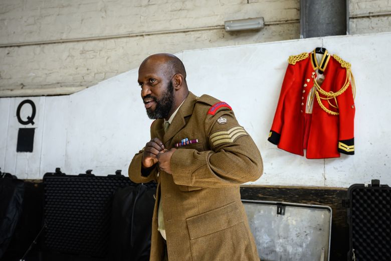 A member of the British Army's Household Cavalry puts on his uniform during preparations for the state visit.