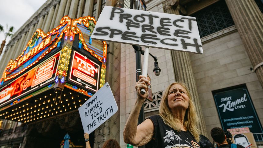 A demonstrator holds a sign reading "Protect Free Speech" outside the El Capitan Theatre, home of "Jimmy Kimmel Live!," on Hollywood Boulevard in Hollywood, Calif., Thursday, Sept. 18, 2025. Protesters gathered after ABC suspended the late-night show, calling it an attack on free expression. (Photo by David Pashaee / Middle East Images via AFP) (Photo by DAVID PASHAEE/Middle East Images/AFP via Getty Images)          