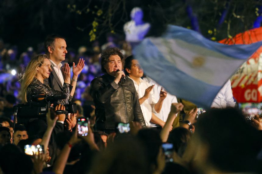 Argentina's President Javier Milei (R) speaks next to legislative candidate Manuel Adorni (C) and Argentina's Secretary General of the Presidency Karina Milei during an open-air political rally at Parque Sarmiento in Cordoba, Argentina on September 19, 2025.