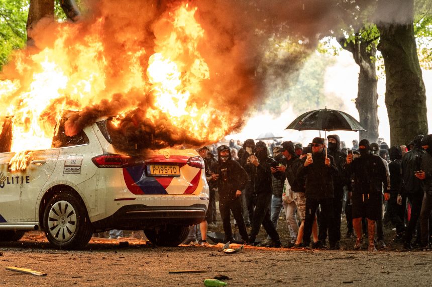 A police car is set on fire during the "Stand up for the Netherlands" demonstration against the government's current asylum seekers policy, in The Hague, on Saturday.