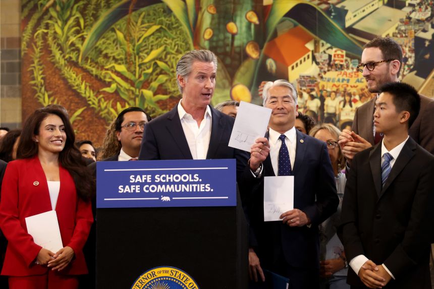 California Gov. Gavin Newsom signs a package of immigration bills at Contreras High School in Los Angeles on September 20, 2025.