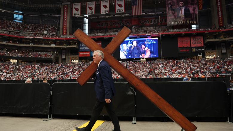 A large cross is wheeled in ahead of the public memorial service for Charlie Kirk at State Farm Stadium in Glendale, Arizona, on Sunday.