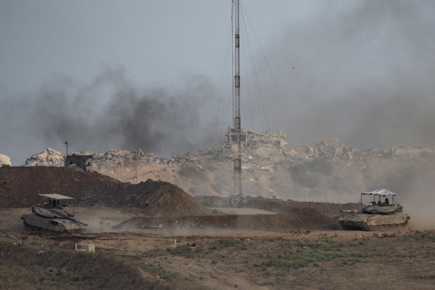 Tanks move inside Gaza, as seen from the Israeli side of the border, on September 22